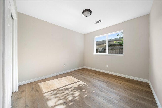 unfurnished bedroom with light wood-type flooring and a closet