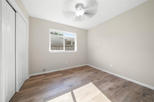 unfurnished bedroom with light wood-type flooring, a closet, and ceiling fan