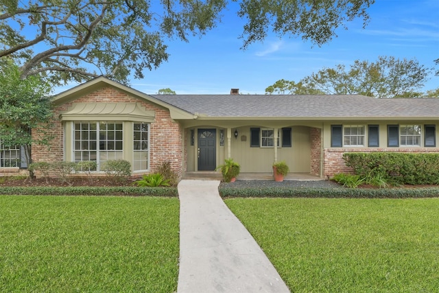 ranch-style home featuring a porch and a front lawn