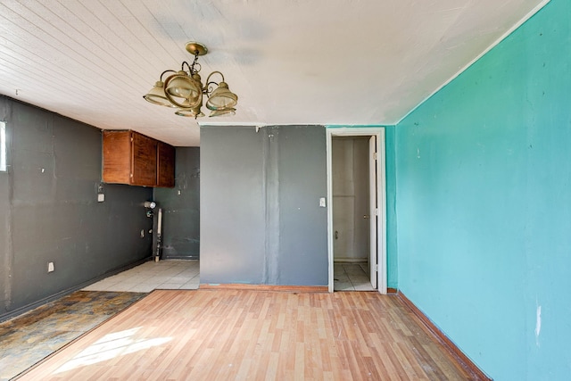 interior space with a notable chandelier and light wood-type flooring