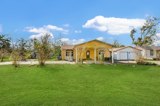 rear view of house featuring a lawn and a garage