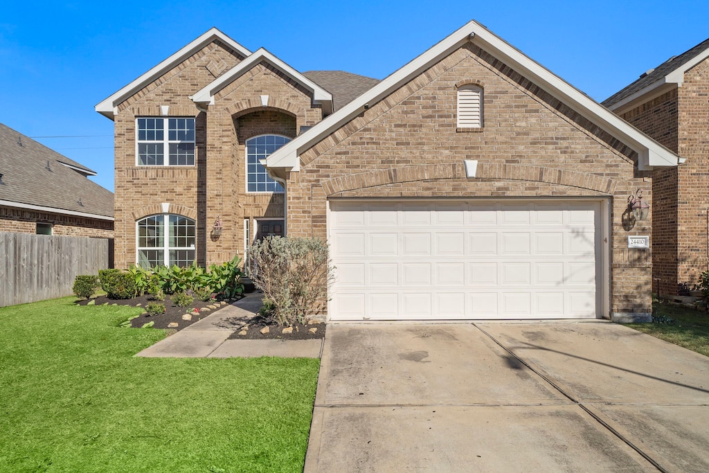 view of front property with a front yard and a garage