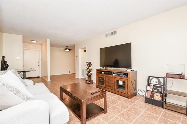 tiled living room featuring ceiling fan