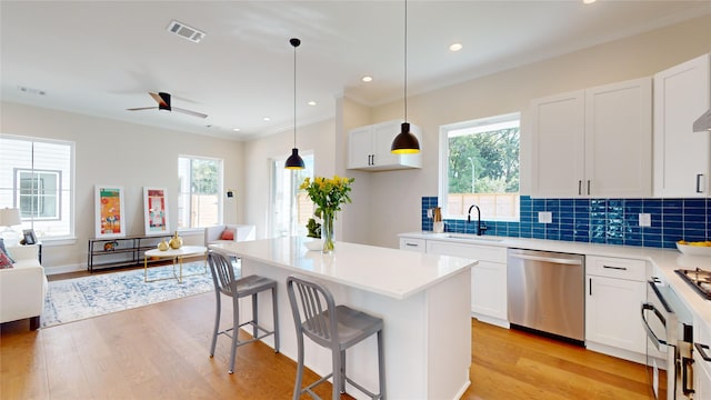 kitchen with sink, stainless steel dishwasher, ceiling fan, light hardwood / wood-style floors, and white cabinetry