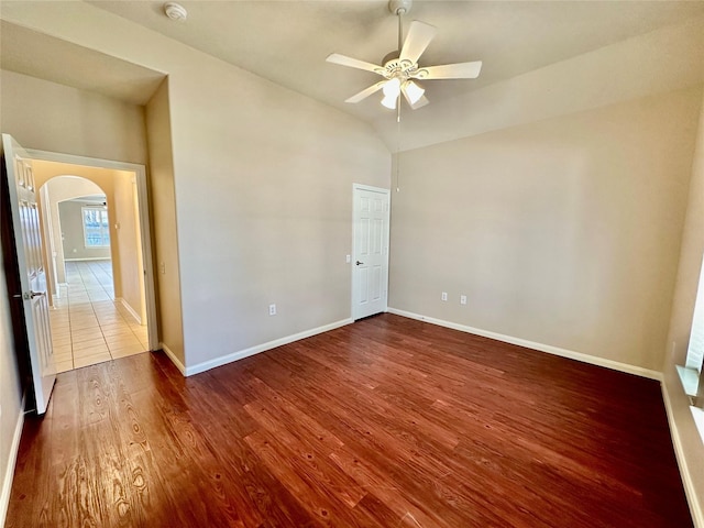 spare room featuring hardwood / wood-style floors, vaulted ceiling, and ceiling fan