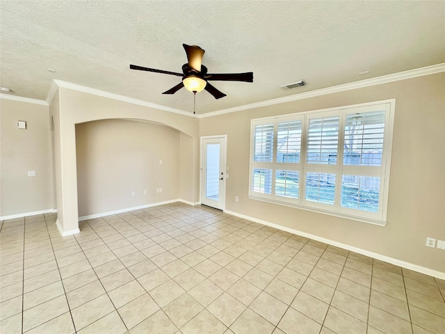 spare room featuring light tile patterned floors, a textured ceiling, ceiling fan, and ornamental molding