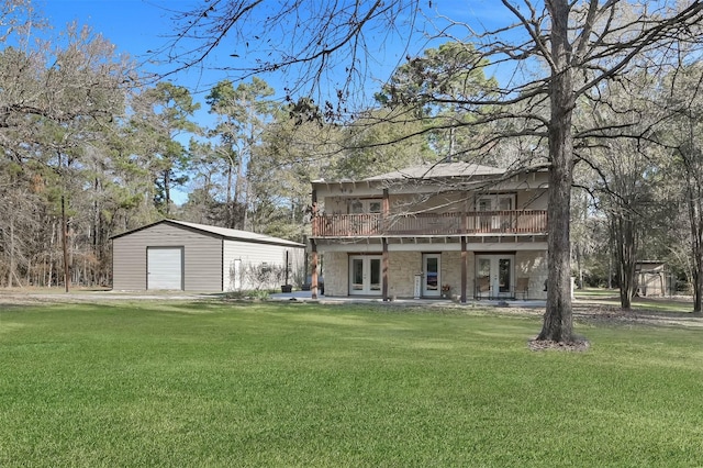 rear view of house with an outbuilding, french doors, a yard, and a patio