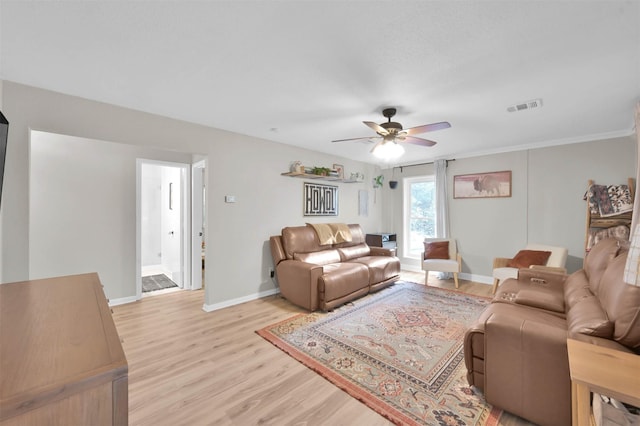 living room with ceiling fan and light hardwood / wood-style flooring