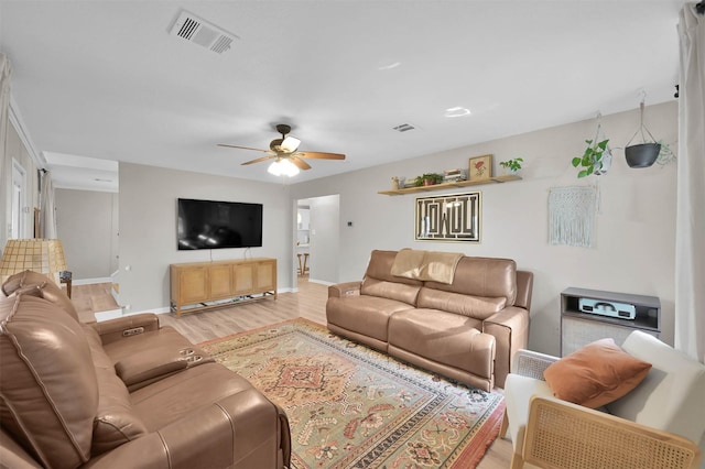 living room featuring ceiling fan and light wood-type flooring