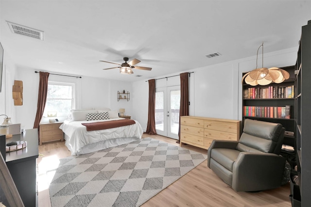 bedroom featuring french doors, light wood-type flooring, access to outside, and ceiling fan