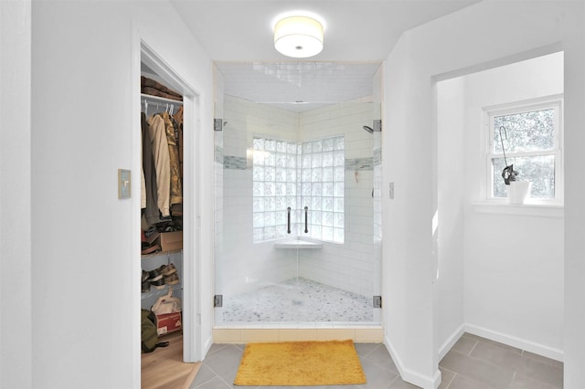 bathroom with tile patterned floors and a shower with shower door