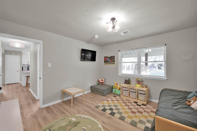 interior space featuring light hardwood / wood-style floors and a textured ceiling