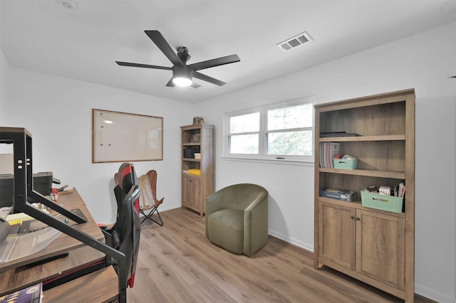 home office with ceiling fan and light hardwood / wood-style flooring