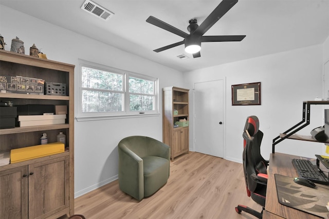 home office with ceiling fan and light hardwood / wood-style flooring