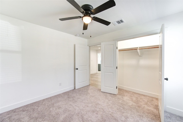 unfurnished bedroom with a closet, ceiling fan, and light colored carpet