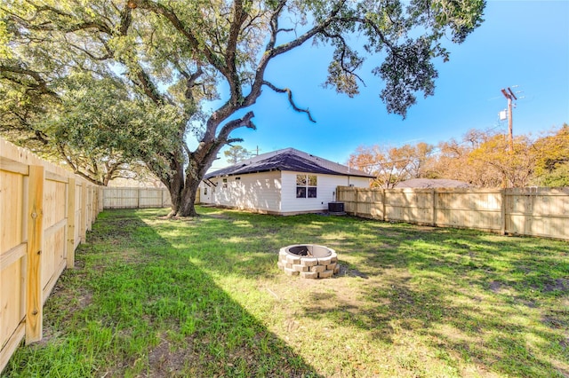 view of yard with a fire pit and cooling unit