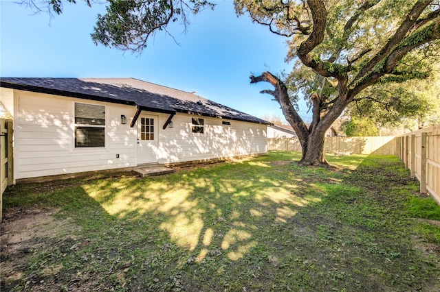 back of house featuring a yard