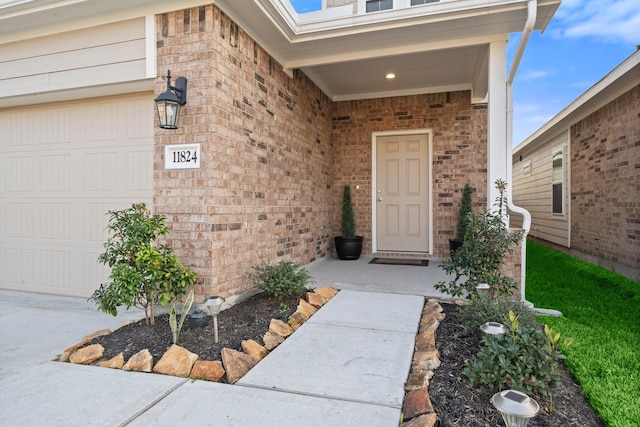 view of exterior entry with a garage