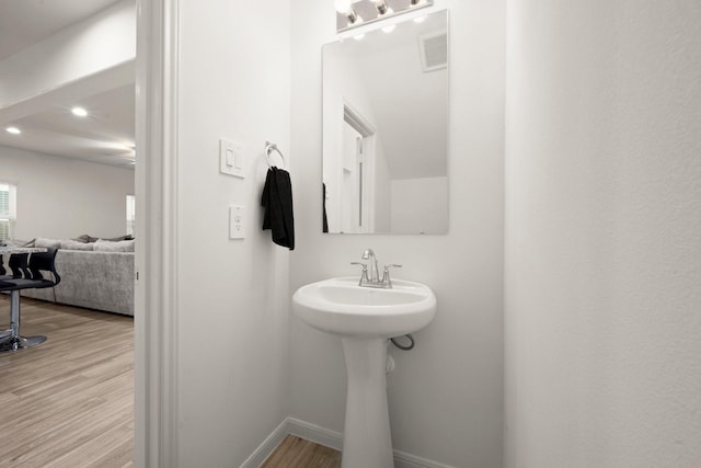 bathroom with hardwood / wood-style flooring and sink