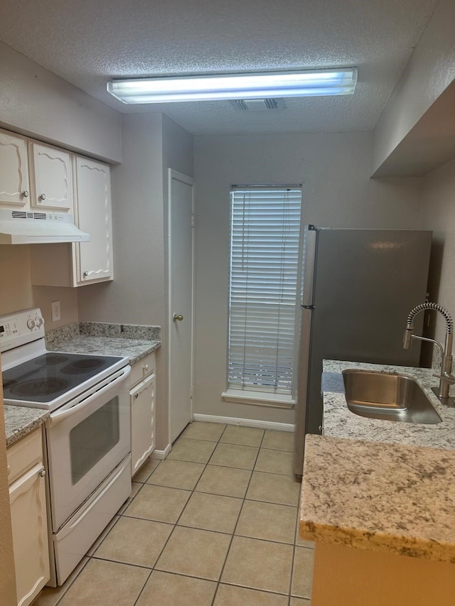 kitchen with electric stove, sink, white cabinets, and light tile patterned floors