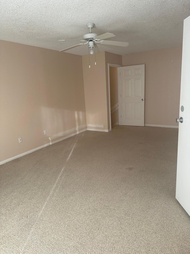 unfurnished room featuring ceiling fan, carpet, and a textured ceiling