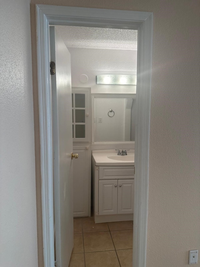 bathroom featuring vanity, a textured ceiling, and tile patterned floors