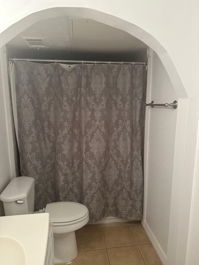 bathroom with tile patterned floors, vanity, and toilet