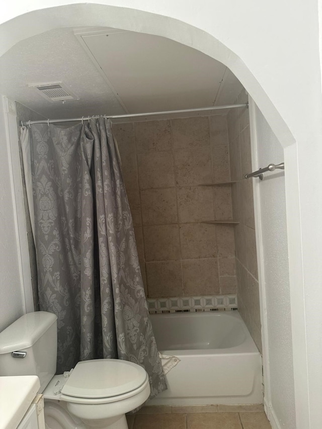 full bathroom featuring tile patterned floors, shower / bath combination with curtain, toilet, and vanity