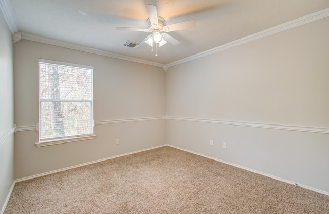 empty room with ceiling fan, carpet floors, and ornamental molding