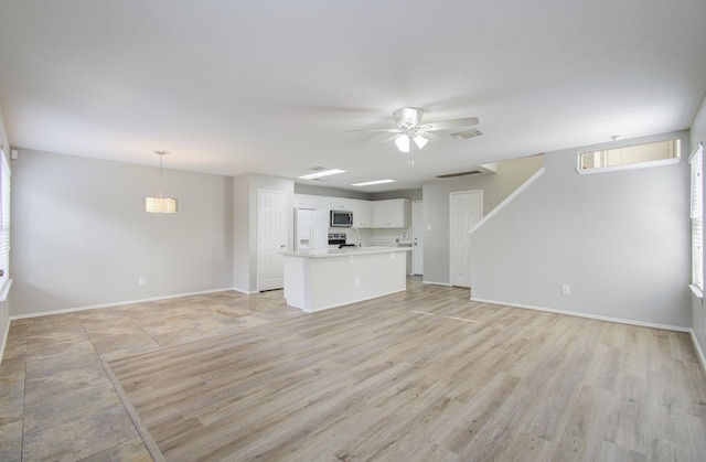 unfurnished living room with ceiling fan and light wood-type flooring