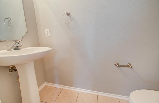 bathroom with tile patterned flooring and toilet