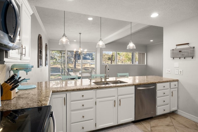 kitchen with white cabinets, sink, and hanging light fixtures