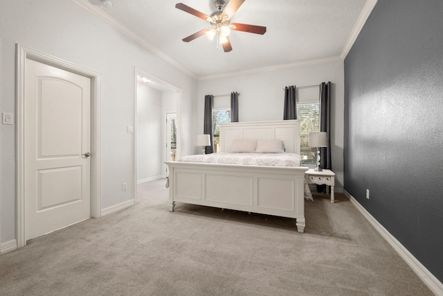 carpeted bedroom with ceiling fan and ornamental molding