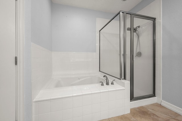 bathroom featuring tile patterned flooring and shower with separate bathtub