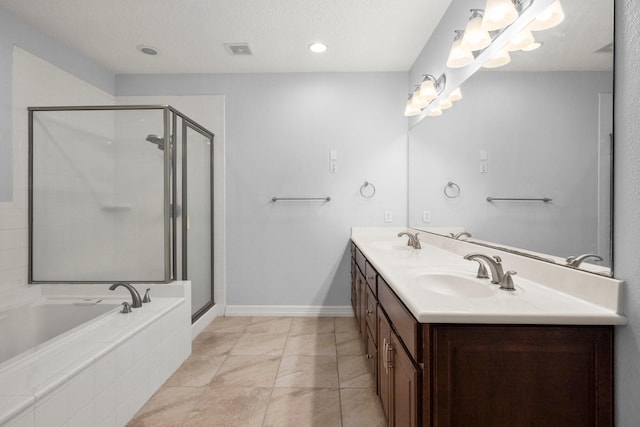 bathroom with tile patterned floors, vanity, plus walk in shower, and a textured ceiling