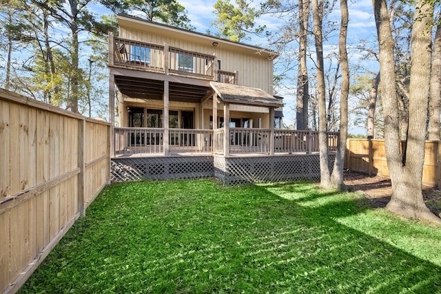 rear view of property with a lawn and a deck