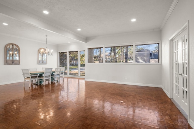 unfurnished dining area with dark parquet floors, a textured ceiling, an inviting chandelier, and ornamental molding