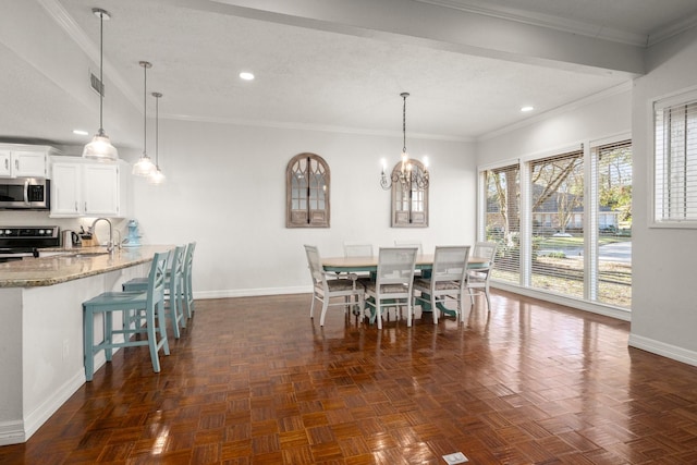 unfurnished dining area with dark parquet flooring, sink, a notable chandelier, crown molding, and a textured ceiling