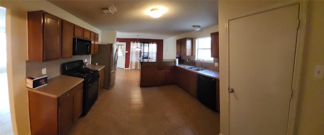 kitchen with sink, black appliances, and kitchen peninsula