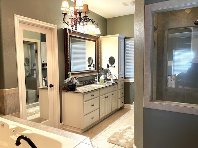 bathroom with tile patterned flooring, vanity, and a notable chandelier