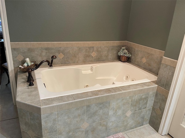 bathroom featuring tile patterned flooring and a relaxing tiled tub