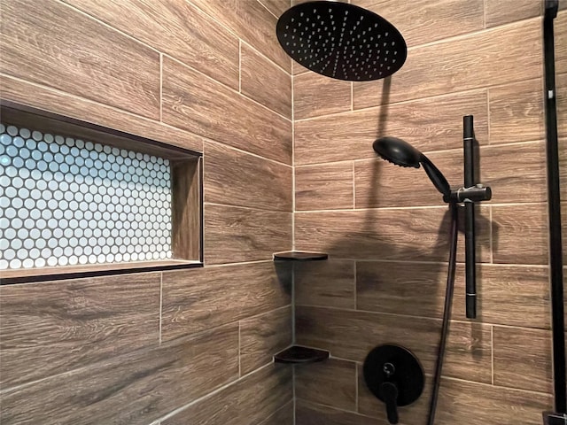 interior details featuring a tile shower