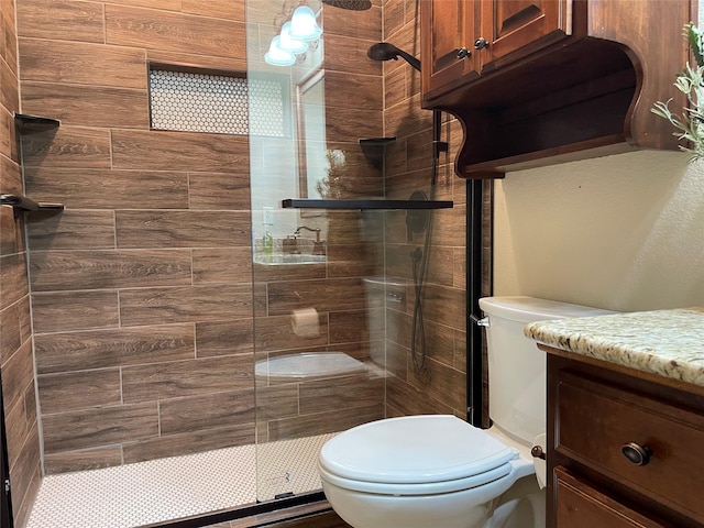 bathroom with vanity, toilet, and a shower with shower door