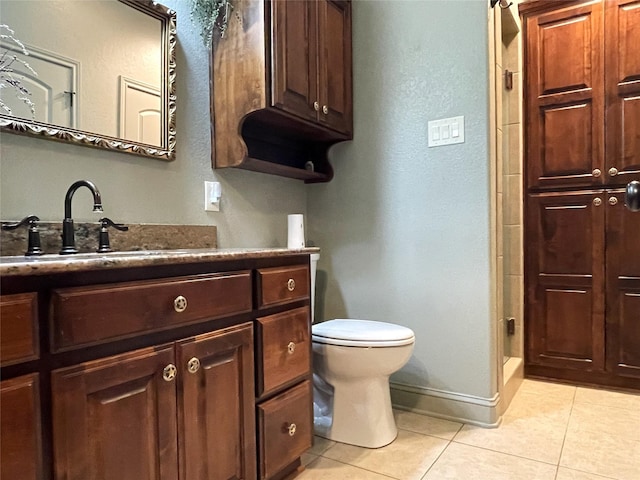 bathroom featuring tile patterned flooring, vanity, toilet, and a shower