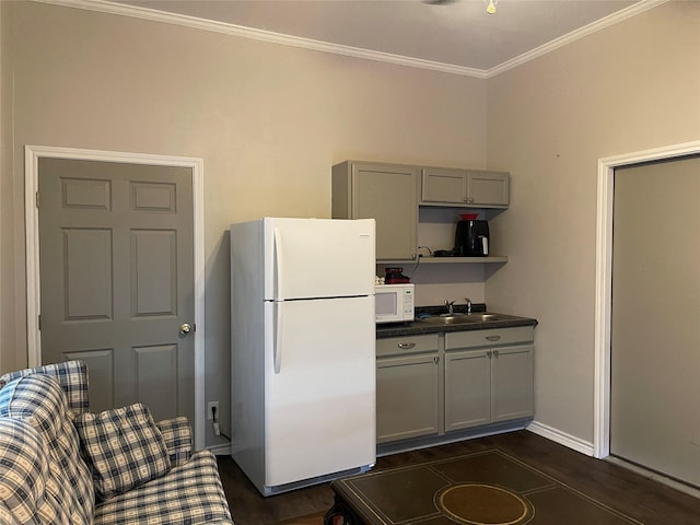 kitchen with gray cabinetry, white appliances, dark wood-type flooring, crown molding, and sink