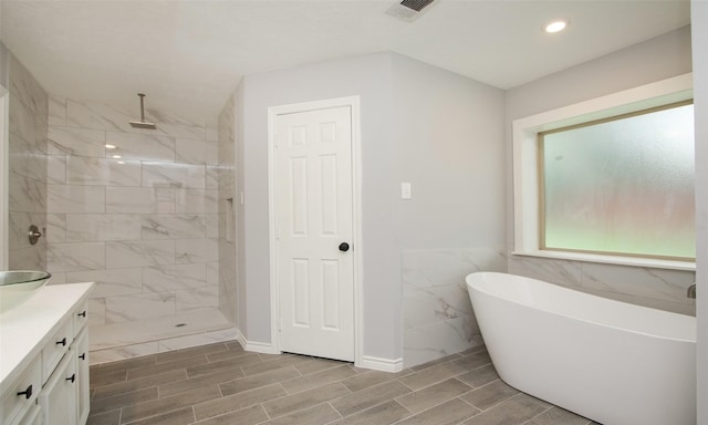 bathroom with vanity and independent shower and bath