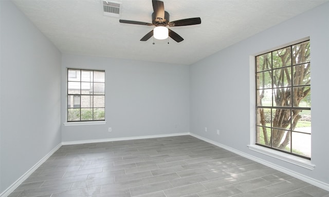 spare room with a textured ceiling and ceiling fan