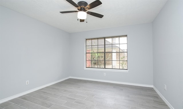 spare room featuring ceiling fan and a textured ceiling