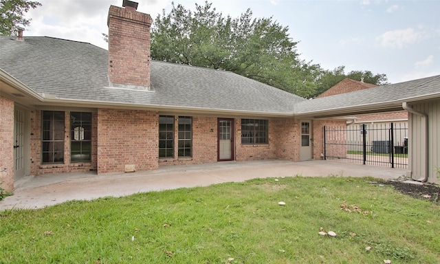 back of house with a lawn