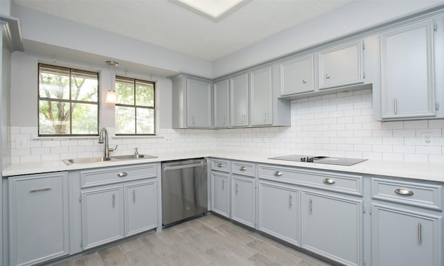 kitchen with stainless steel dishwasher, gray cabinets, black electric stovetop, and sink